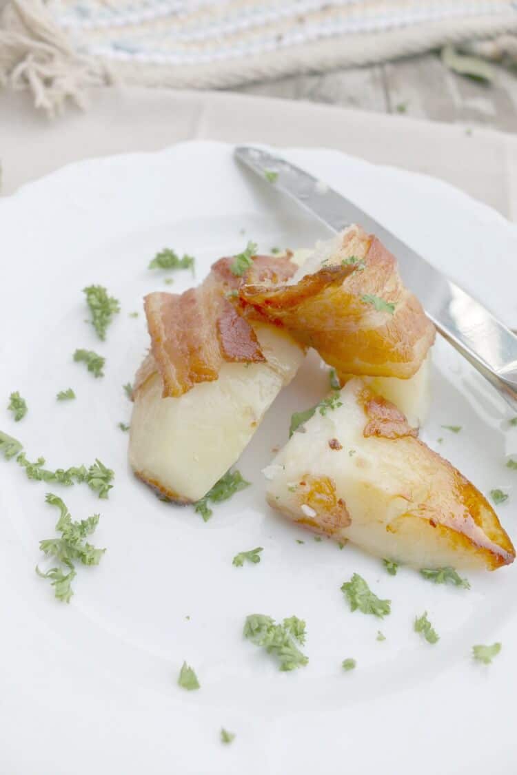 Bacon Wrapped Potato Wedges - this 2-ingredient dish will be a hit at your table. There is a trick to making the potatoes tender and tasty, click to find out what it is!