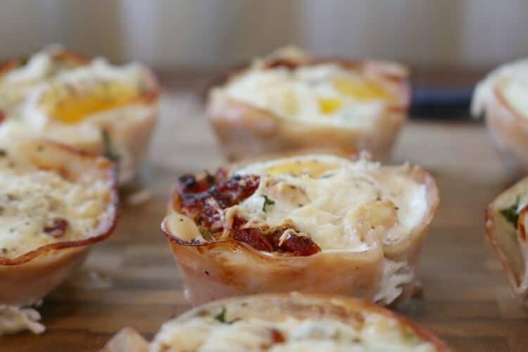 Breakfast Kale Egg Cups with Parmesan and Sun Dried Tomatoes - Great as a quick grab-n-go breakfast (from the freezer) or a nice staple at a relaxing brunch. Click to find this easy recipe!